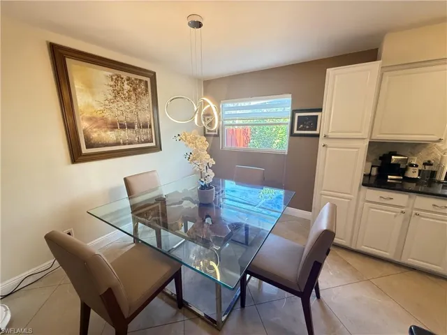 Dining room featuring light tile patterned flooring and baseboards