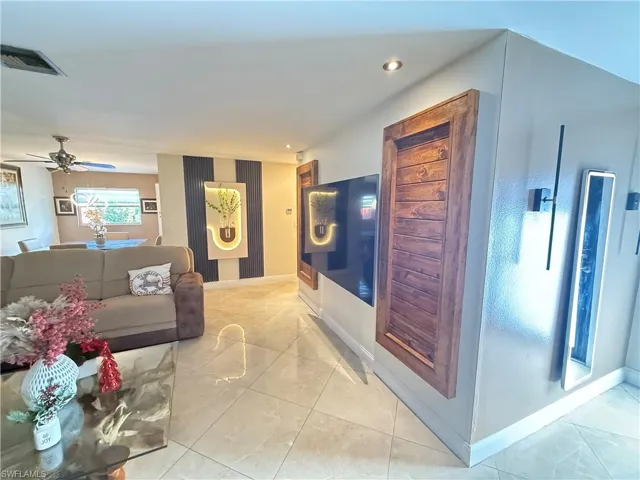 Living area featuring light tile patterned floors, recessed lighting, and a ceiling fan