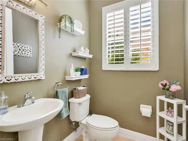 Bathroom with toilet and baseboards