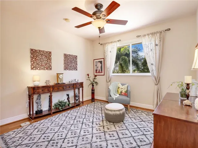 Sitting room with a ceiling fan and light wood-style floors