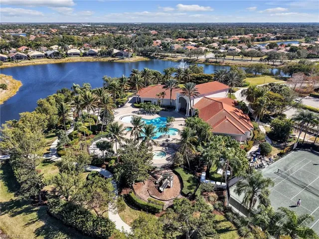 Aerial view of residential area featuring a large body of water and a pool