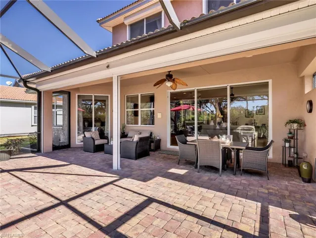View of patio / terrace featuring a lanai, outdoor lounge area, a sunroom, and a ceiling fan