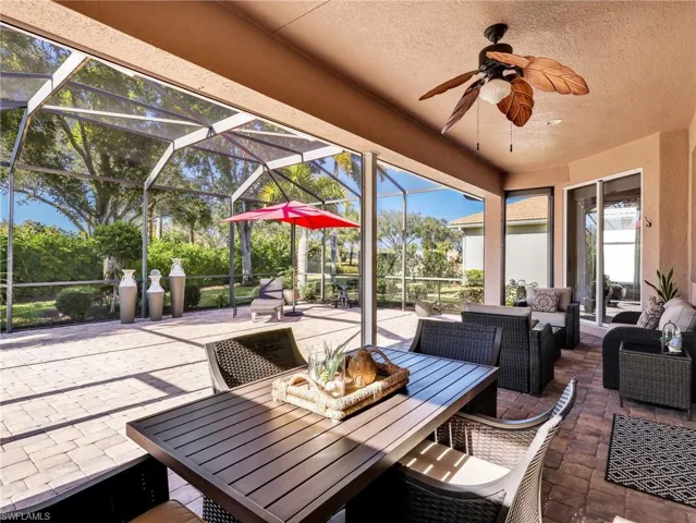 View of patio / terrace featuring ceiling fan, a lanai, a sunroom, and outdoor lounge area