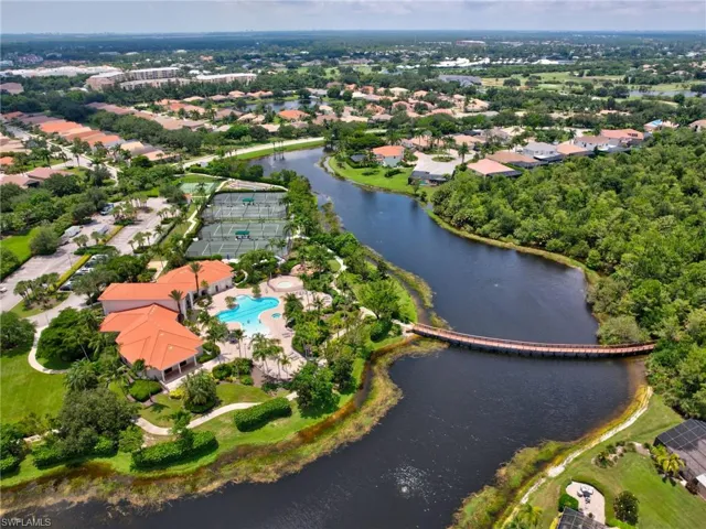 Aerial view of property's location with a nearby body of water and a pool area