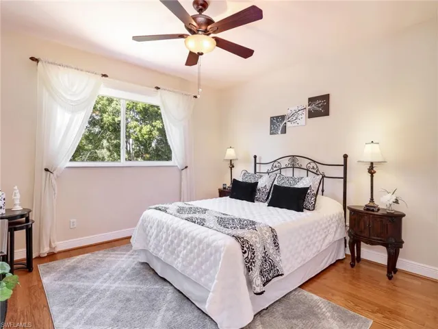 Bedroom with light wood-style floors and ceiling fan