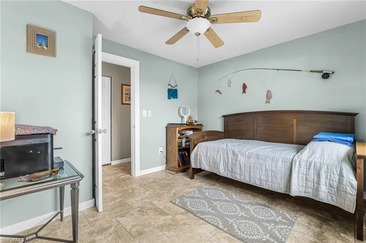 Bedroom featuring lofted ceiling and a ceiling fan
