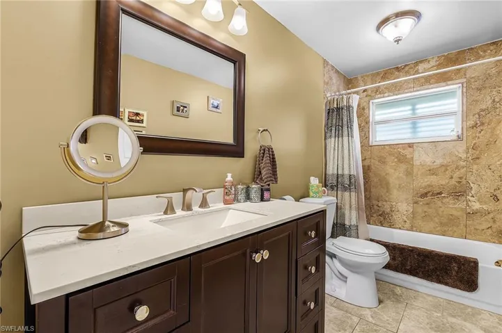 Full bath with vanity and shower / bathtub combination with curtain