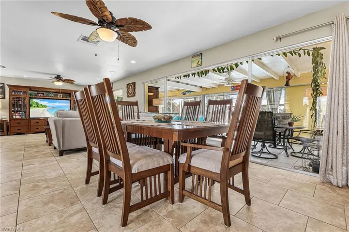 Dining space featuring a ceiling fan, healthy amount of natural light, and recessed lighting