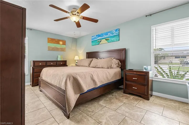 Bedroom featuring ceiling fan and light tile patterned flooring