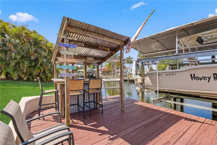 Dock with boat lift and a water view