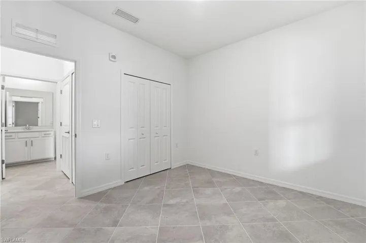 Unfurnished bedroom featuring a closet and light tile patterned floors