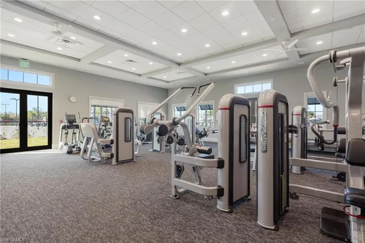 Exercise room with coffered ceiling, beamed ceiling, and recessed lighting