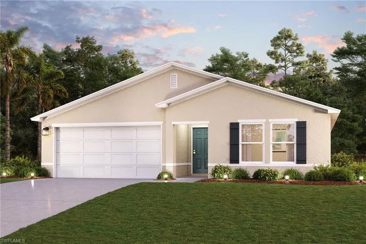View of front of house with a garage and a yard