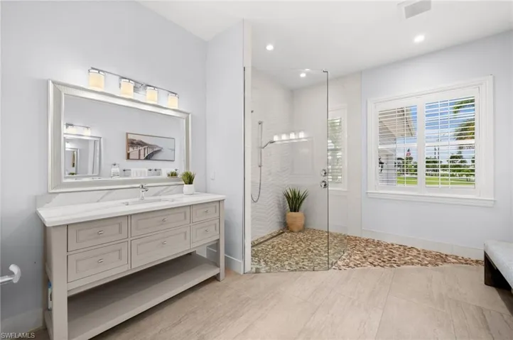 Primary bath with custom tile and glass wet room