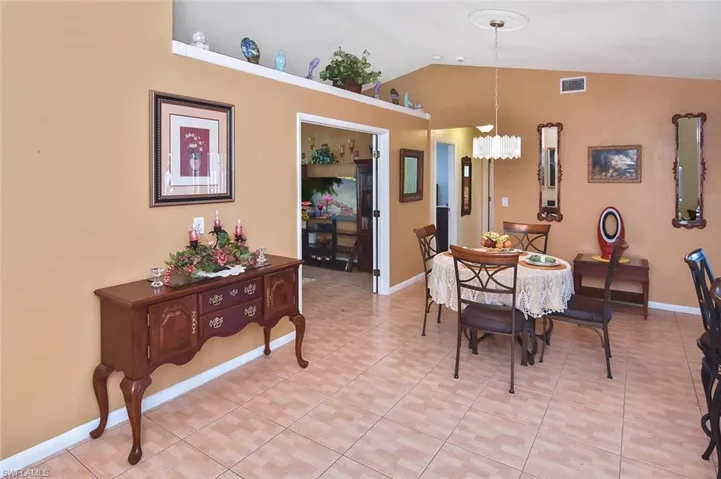 Casual dining with a vaulted-ceiling view into the den and out onto the expansive lanai.