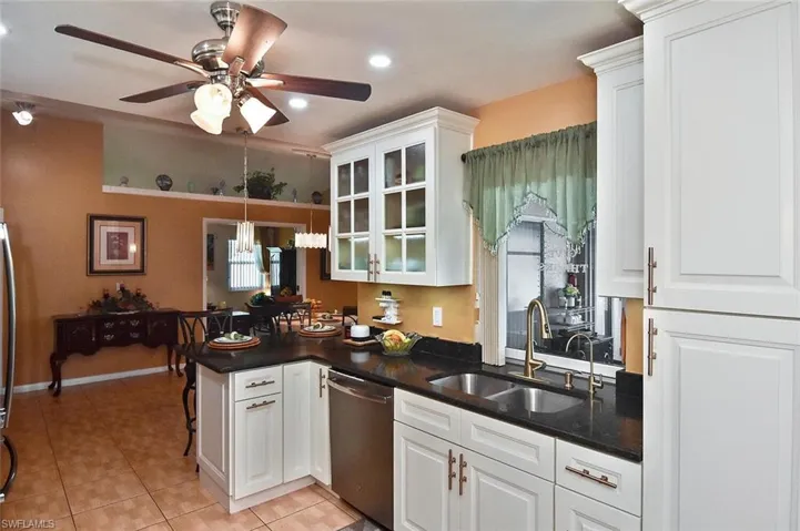 Note the parquet-style wood-look tile, and the pass-through window over the sink.