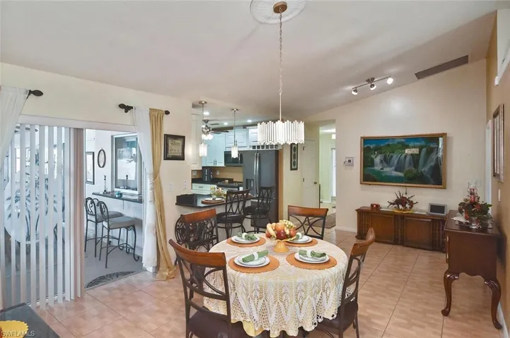Casual dining space with view onto the expansive lanai through 1 of 3 sets of sliders in this home.