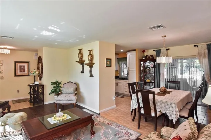 Another view of the living & dining rooms, looking toward the kitchen and one of three sets of sliders to the lanai.