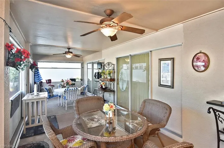 Another view of the lanai showing two ceiling fans and 2 of 3 sets of sliders.