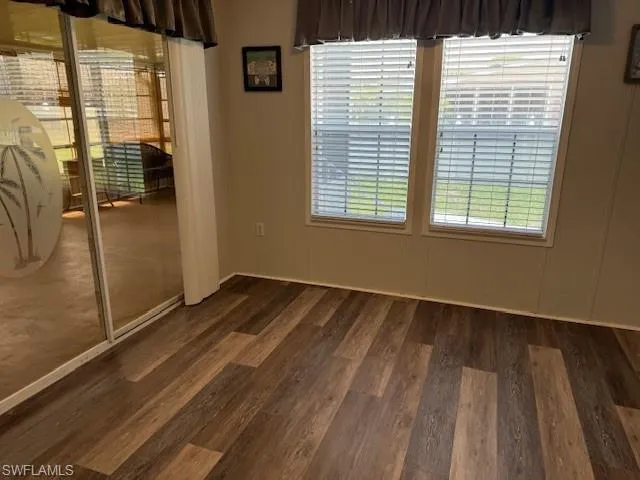 Spare room with dark hardwood / wood-style floors