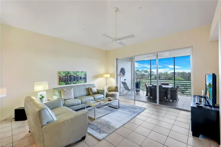 Living room featuring ceiling fan and light tile patterned floors