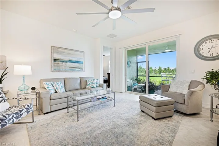 Tiled living room featuring ceiling fan
