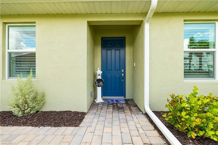Doorway to property with stucco siding
