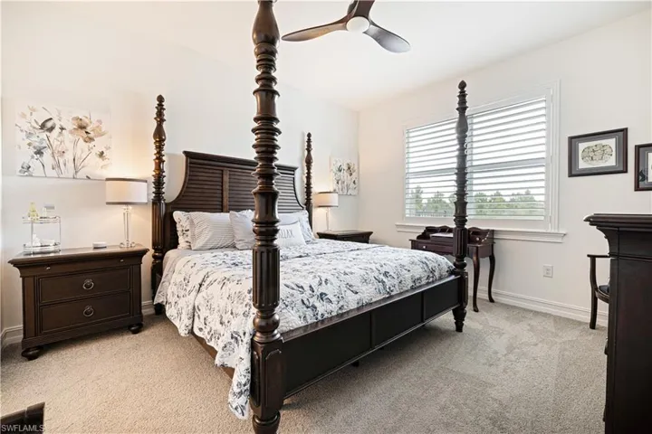 Bedroom with light carpet and ceiling fan