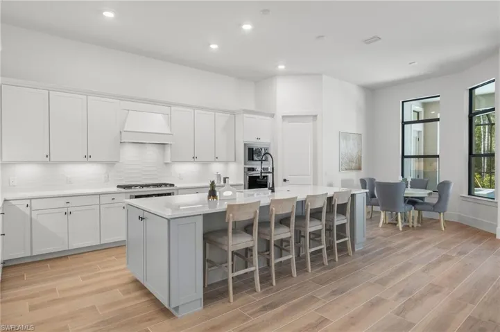 White wall cabinets and grey island cabinets.