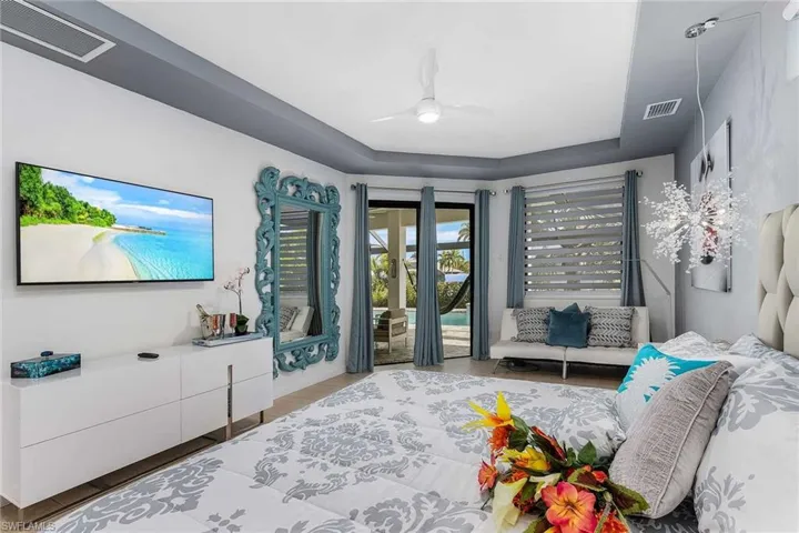 Primary Bedroom w/ flatscreen tv