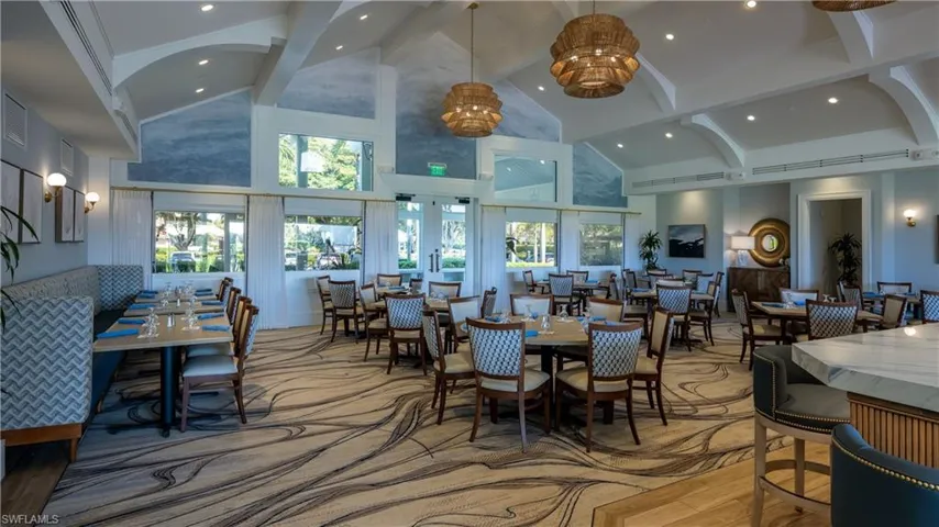 Dining space featuring high vaulted ceiling, beam ceiling, recessed lighting, and light wood finished floors