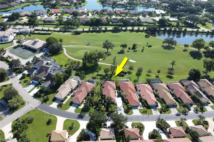 Birds eye view of property with a water view