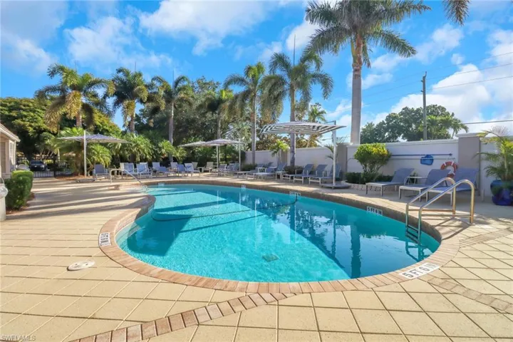 Community pool with a patio