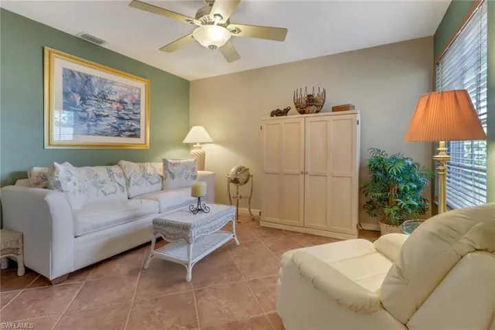Living room featuring ceiling fan and light tile patterned floors