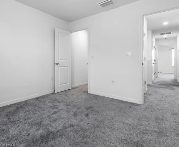 Unfurnished bedroom featuring carpet floors and baseboards