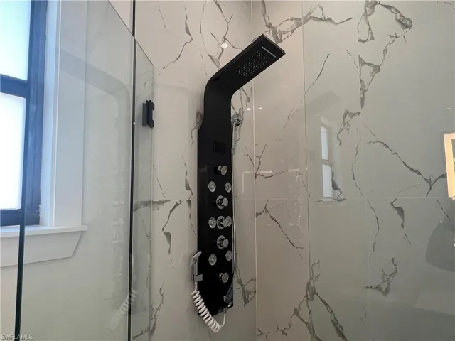 Room details with tiled shower