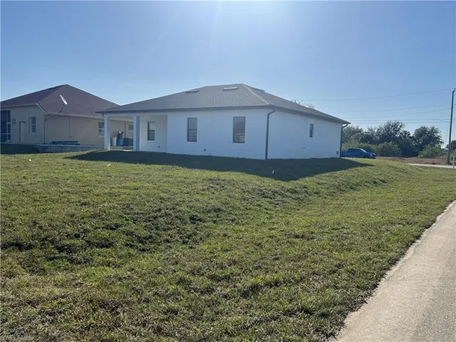 View of side of property with a lawn