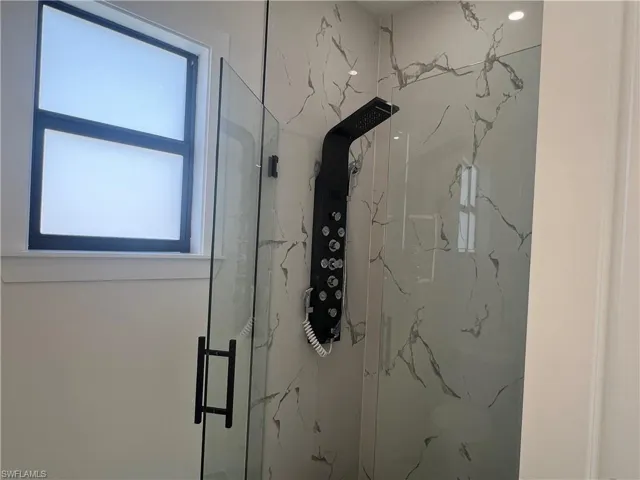 Bathroom with a shower with door