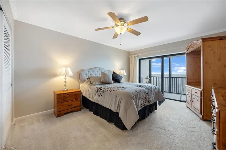 Bedroom featuring light colored carpet, ceiling fan, access to outside, and crown molding