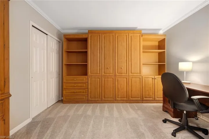 Office featuring crown molding and light colored carpet
