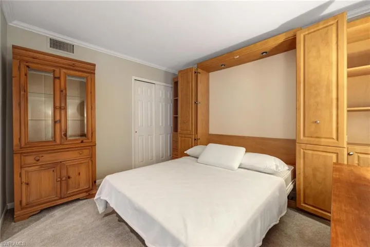 Carpeted bedroom featuring ornamental molding