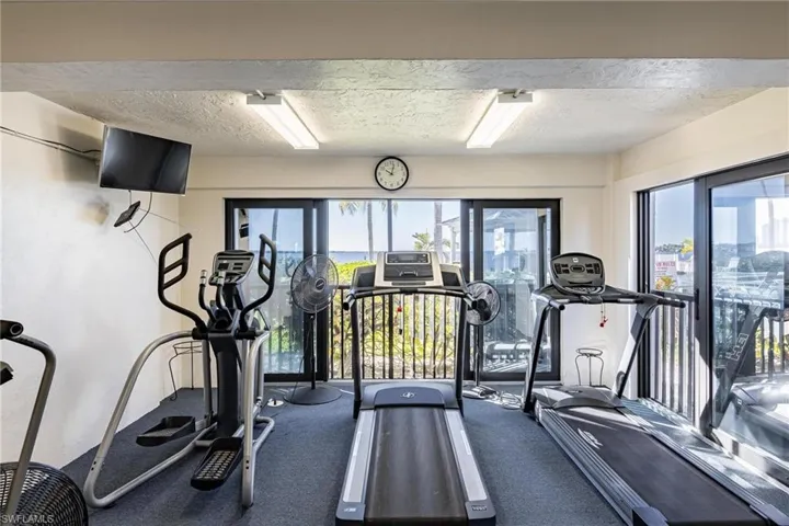 Gym featuring carpet and a textured ceiling