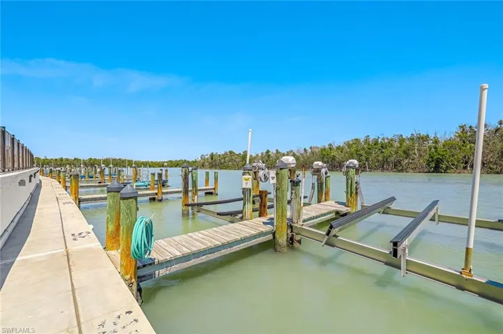 Dock area with a water view and boat lift