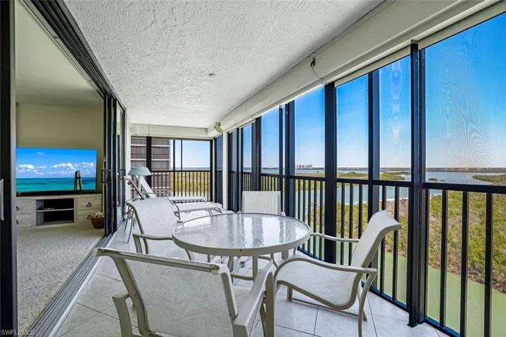 Sunroom featuring a water view