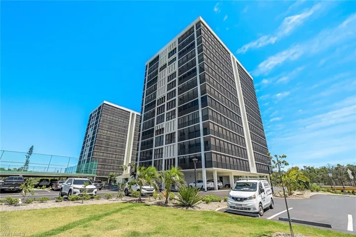 View of property featuring uncovered parking