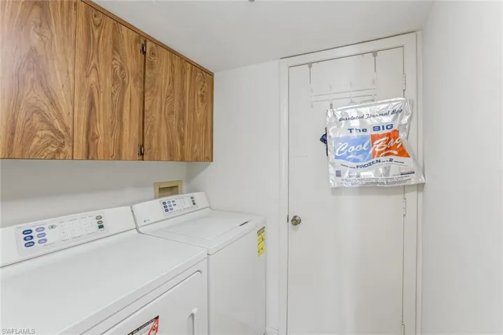 Washroom with washing machine and dryer and cabinet space