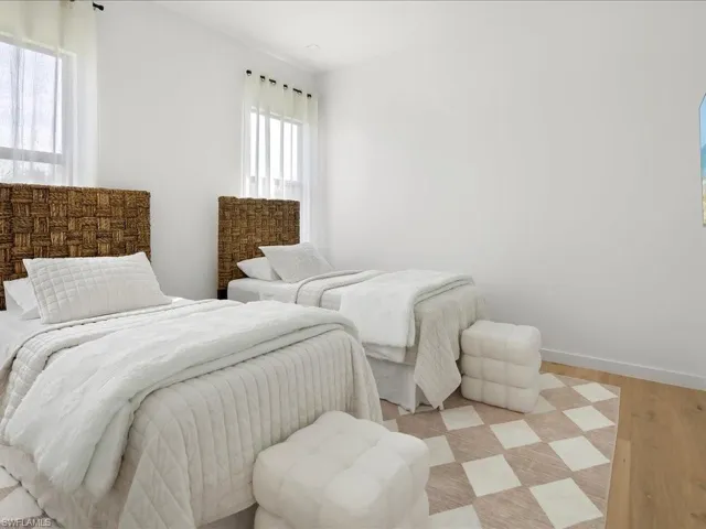 Bedroom featuring baseboards and wood finished floors