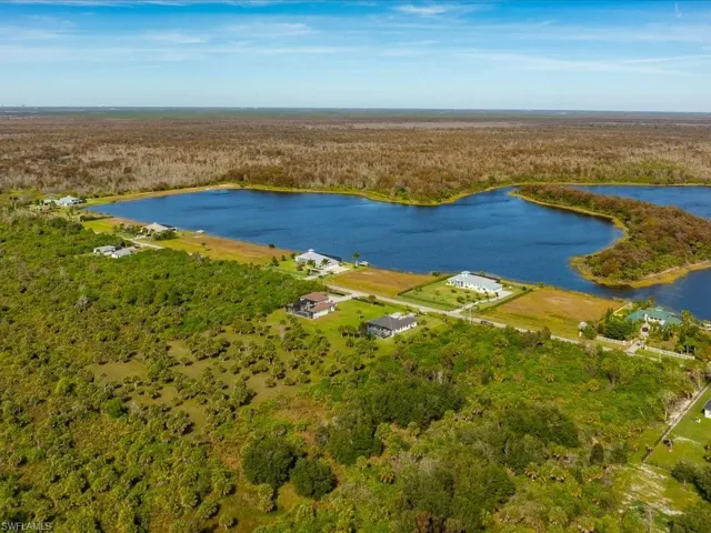 Bird's eye view of a heavily wooded area and a nearby body of water