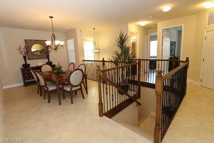 Dining space with an inviting chandelier and light tile patterned floors