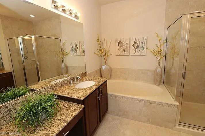 Bathroom with vanity, plus walk in shower, and tile patterned flooring